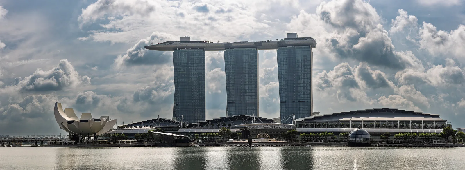 The three Marina Bay Sands towers and SkyPark beside the lotus-shaped ArtScience Museum, seen across the bay